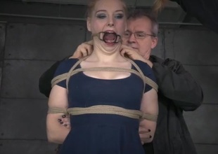 Rope bound girl with small melons takes a whipping